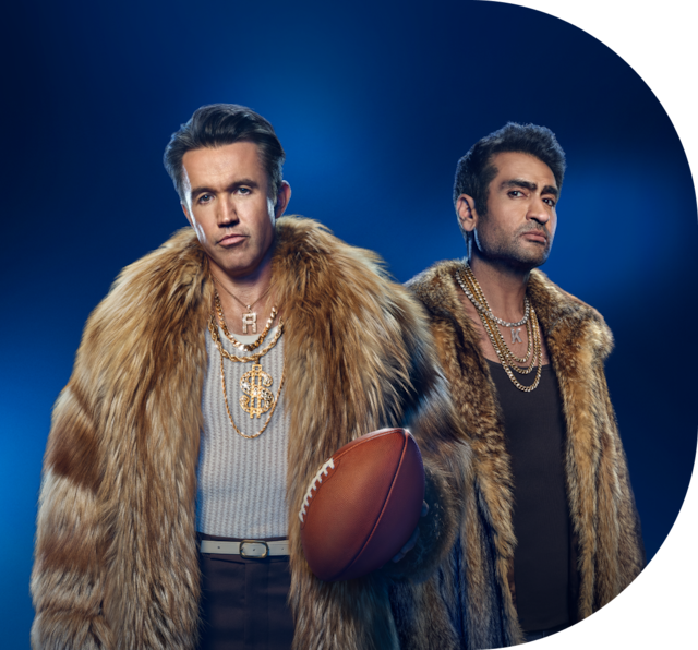 Two Men in fur coats promoting sports streaming